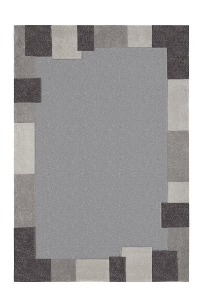 Rechteckiger Teppich mit grauem Mittelfeld und einer Bordüre aus versetzten, verschiedenfarbigen Rechtecken in Grautönen.