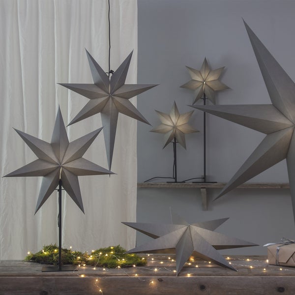 Dekorative Sternleuchten auf einem Tisch und einer Ablage