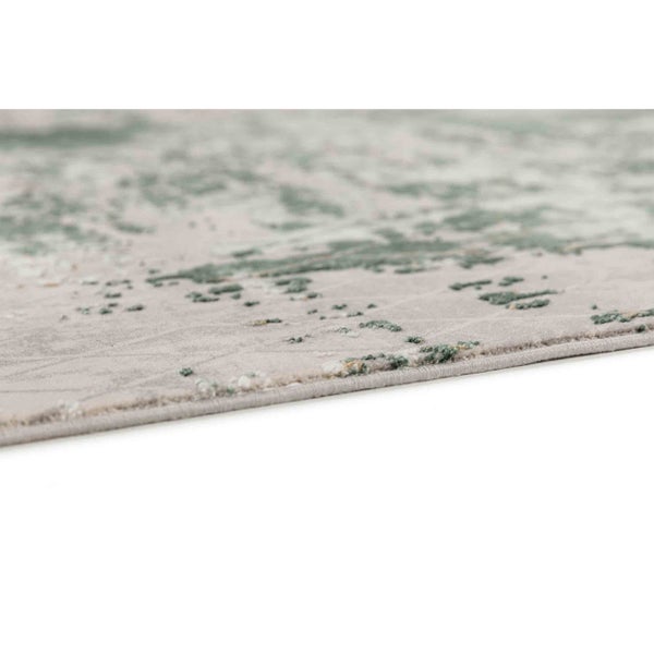 Nahaufnahme eines Kurzflor-Teppichs mit abstraktem Muster und gekettelter Kante.