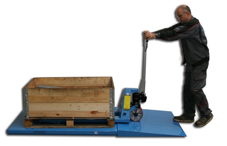 Ein Mitarbeiter bedient einen Hubwagen auf einer Waage mit einer Holzpalette und einer Holzkiste.