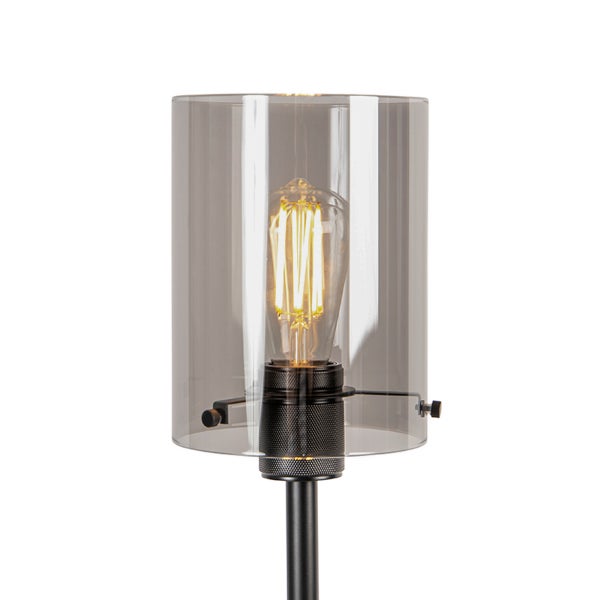 Moderne Leuchte mit zylindrischem Rauchglasschirm und dekorativem Filament-Leuchtmittel im Vintage-Stil.