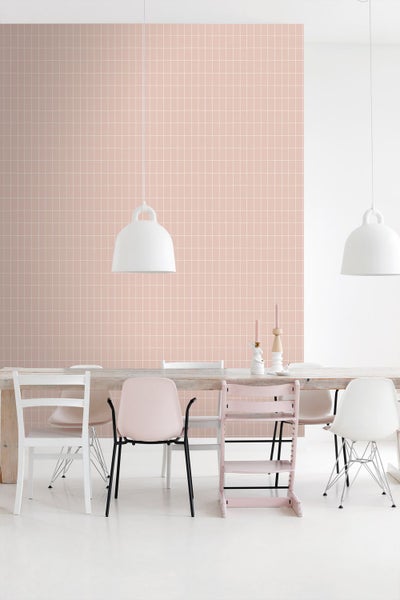 Esszimmer mit Esstisch, Stühlen und Pendelleuchten vor einer Wand mit quadratischen Fliesen