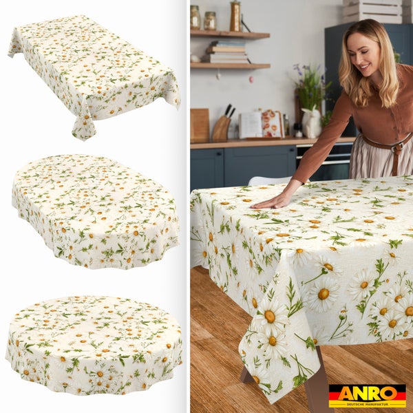 Tischdecke mit Gänseblümchen-Muster in eckiger, ovaler und runder Form, eine Frau an einem Holztisch in einer hellen Küche, ANRO Logo.