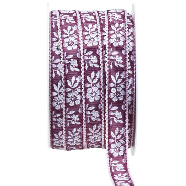 Spule mit dekorativem Zierband mit Blumenmuster