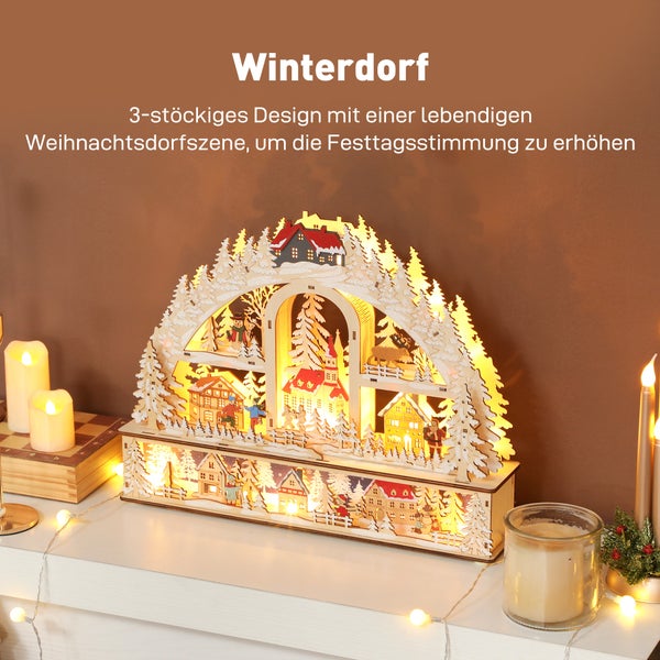 Dreistöckiges beleuchtetes Winterdorf aus Holz mit detaillierten Schnitzereien von Häusern, Tannen und Figuren für die Weihnachtsdekoration.