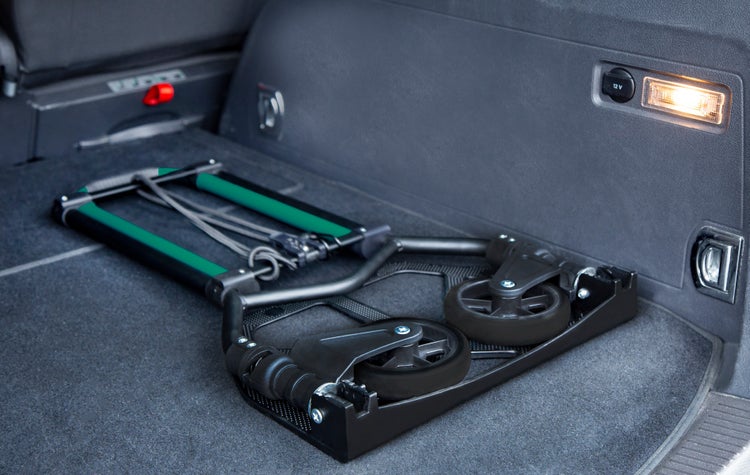 Zusammengeklappte Sackkarre aus Metall im Kofferraum eines Autos verstaut