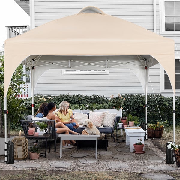 Szene im Freien mit Faltpavillon, Sitzgelegenheit und Gartendekoration für entspannte Stunden im Garten