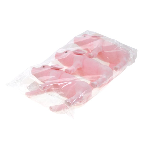 Drei rosa Schweinefiguren in einer Plastikverpackung.