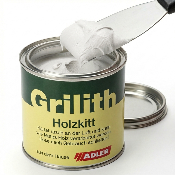 Adler Grilith Holzkitt in einer Metalldose mit einem Spachtel, der die weiße Spachtelmasse entnimmt.