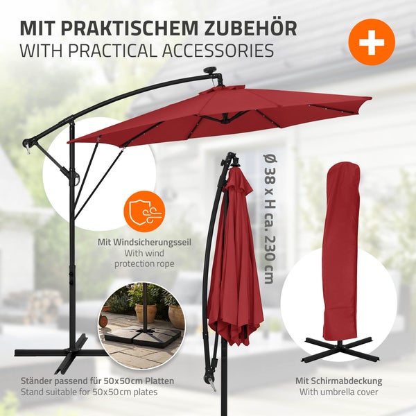 Ampelschirm mit Zubehör wie Windschutzseil, Ständer für Gehwegplatten und Schutzhülle zur sicheren Aufbewahrung im Garten.