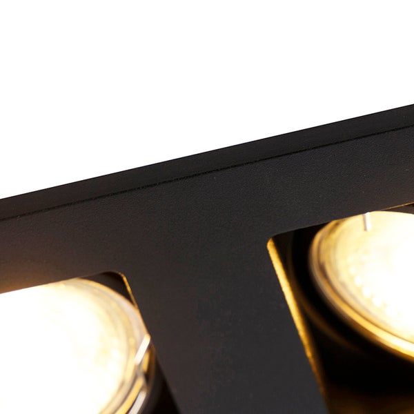 Nahaufnahme einer schwarzen Metallleuchte mit zwei leuchtenden Spots.