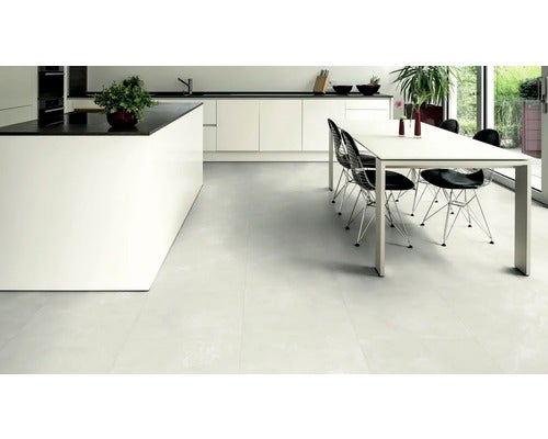 Heller Küchenraum mit Fliesenboden, Kücheninsel und Esstisch