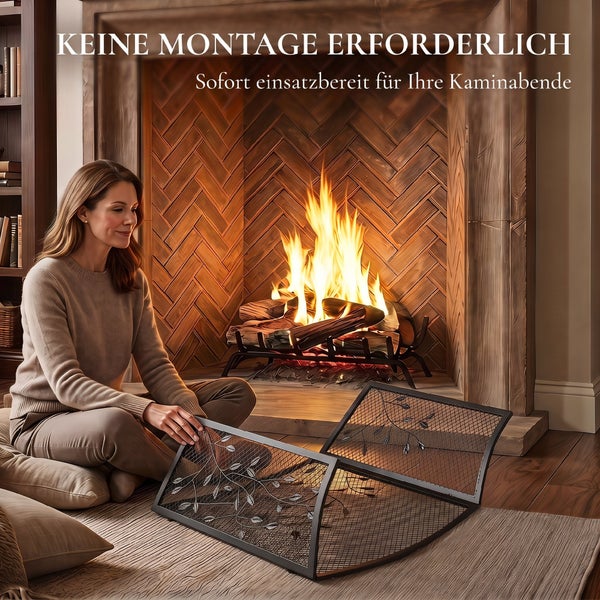 Eine Frau sitzt vor einem Kamin mit brennendem Feuer und platziert einen dekorativen metallenen Funkenschutz mit Blättermotiven.