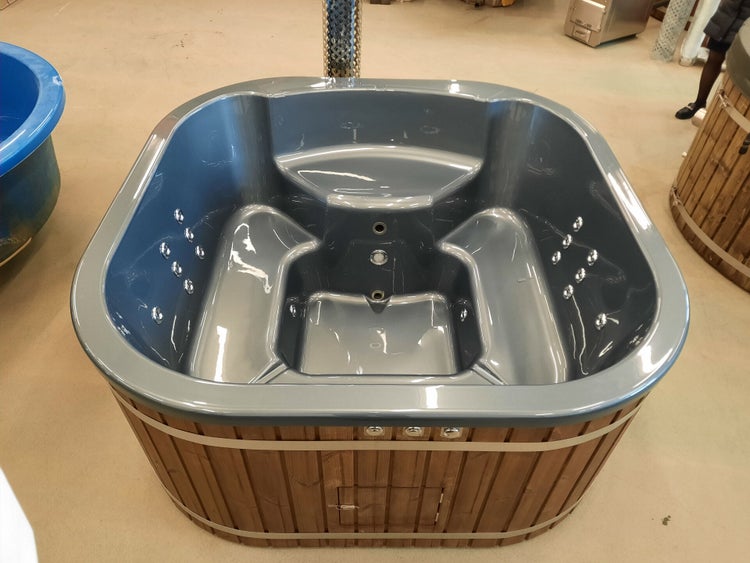 Grauer Whirlpool mit Holzverkleidung