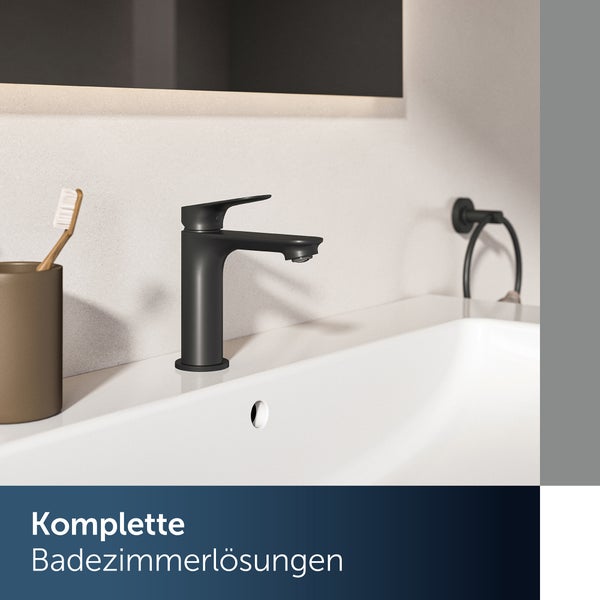Modernes Badezimmer mit Waschtisch, Waschtischarmatur und passenden Accessoires in minimalistischem Design.