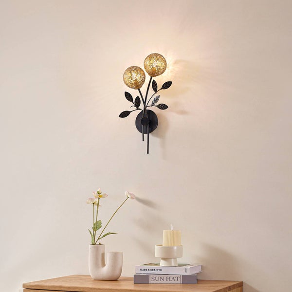 Wandleuchte mit floralem Design und zwei leuchtenden Kugeln