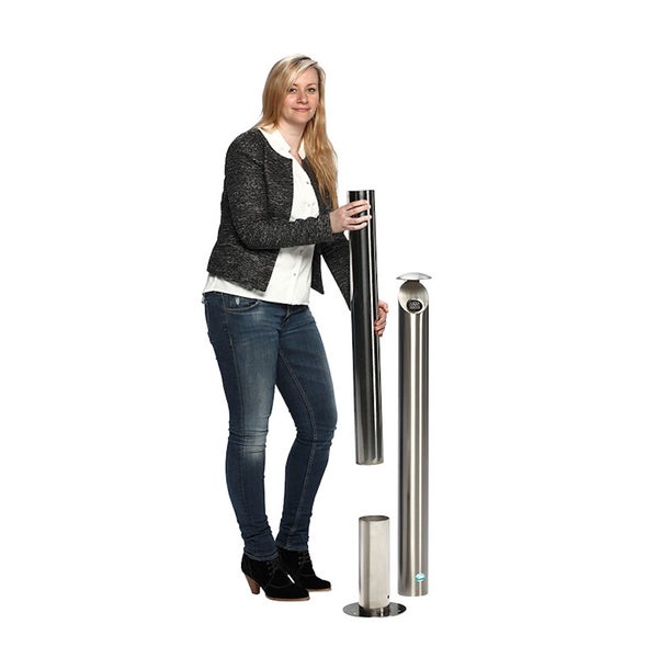 Frau hält den oberen Teil eines hohen Standaschers aus Edelstahl. Daneben ist der montierte Aschenbecher für den Außenbereich zu sehen.