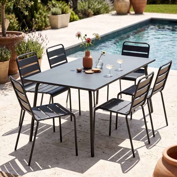Moderne Garten-Essgruppe mit rechteckigem Metalltisch und sechs Stapelstühlen mit Lamellen auf einer Terrasse neben einem Pool.