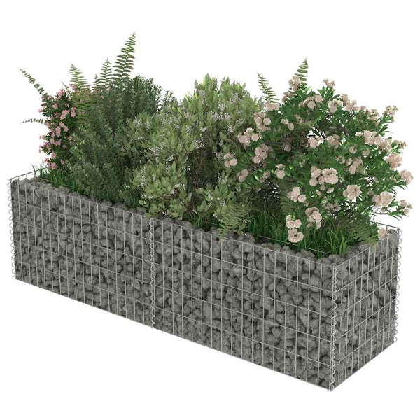 Gabione mit grauen Steinen befüllt und mit verschiedenen Sträuchern, Farnen und Blumen bepflanzt.