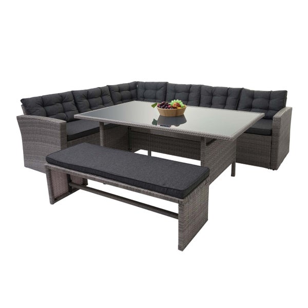 Polyrattan Garten-Lounge-Set bestehend aus Ecksofa, Esstisch mit Glasplatte und Sitzbank inklusive dunklen Polstern.