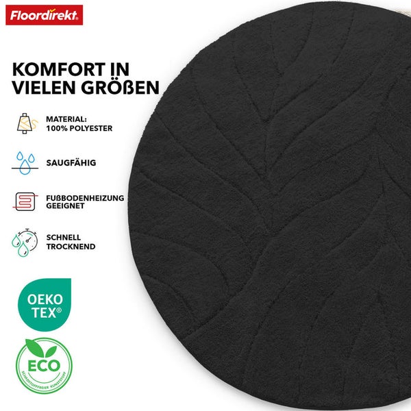 Runder, schwarzer Badteppich mit Blattmuster aus 100 Prozent Polyester. Geeignet für Fußbodenheizung, saugfähig und schnell trocknend. Öko-Tex Standard 100 und Eco Siegel.