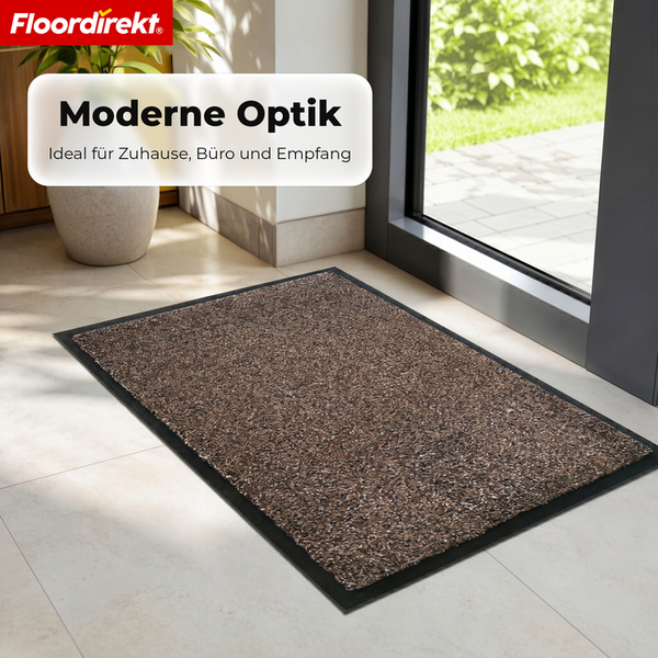 Moderne Schmutzfangmatte mit melierter brauner Oberfläche und schwarzem Rand vor einer hellen Glastür im Innenbereich. Floordirekt Logo.