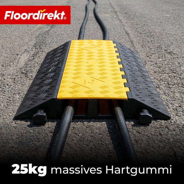 Gelb-schwarze Kabelbrücke aus massivem Hartgummi, 25 Kilogramm schwer, mit zwei Kabelkanälen und profilierter Oberfläche. Floordirekt Logo.