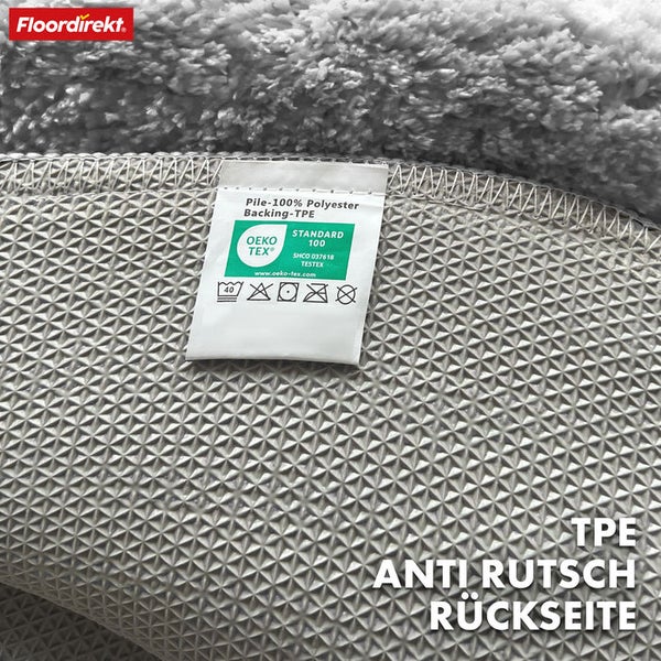 Rückseite eines Teppichs mit dem Hinweis rutschfest, OEKO-TEX Siegel, Material aus Polyester