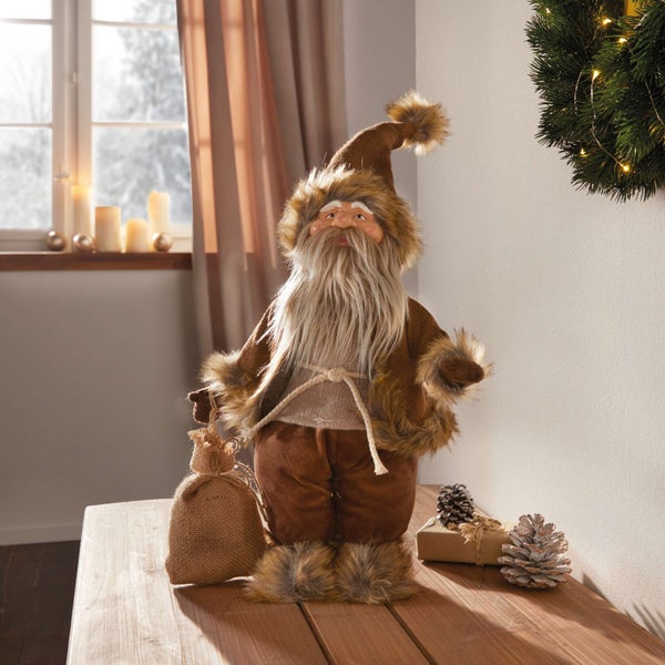 Dekorativer Weihnachtsmann mit Sack auf einem Tisch