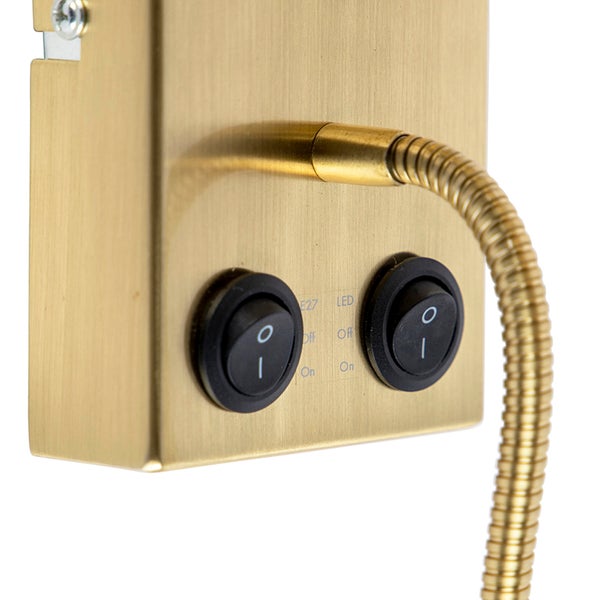 Detailansicht einer goldenen Lampe mit zwei Schaltern