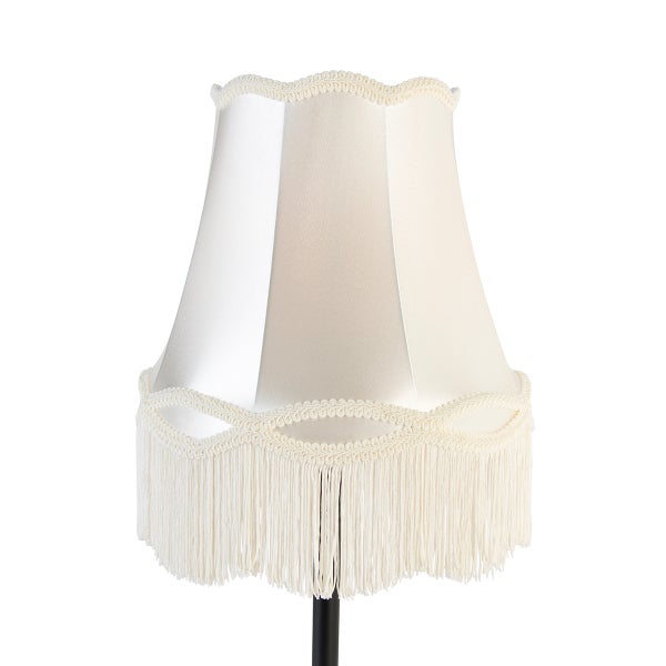 Klassischer cremefarbener Lampenschirm mit dekorativer Borte und Fransen, konische Form.