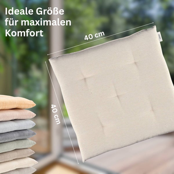 Quadratisches Sitzkissen mit Esprit Logo aus geripptem Stoff, Größe 40 mal 40 Zentimeter, und ein Stapel weiterer Kissen.