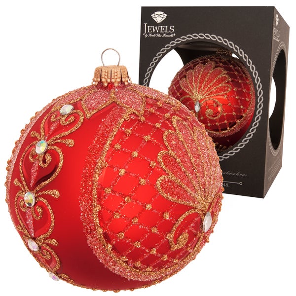 Rote Christbaumkugel mit Schmuckornamenten und Verpackung