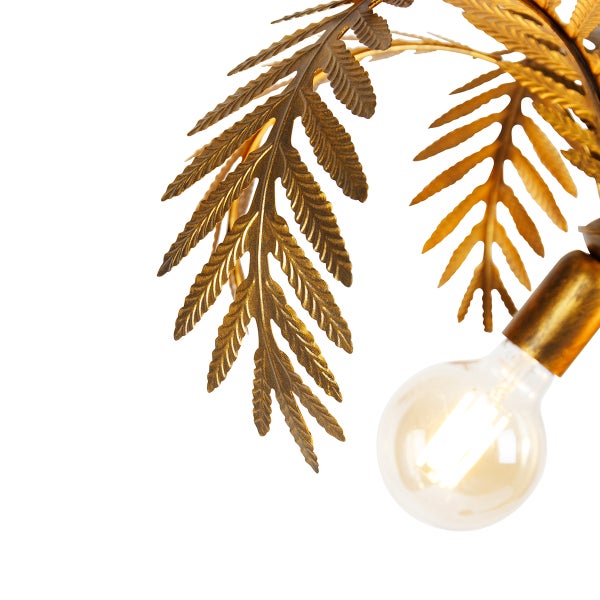 Nahaufnahme einer dekorativen Lampe mit Blattdesign und Glühbirne