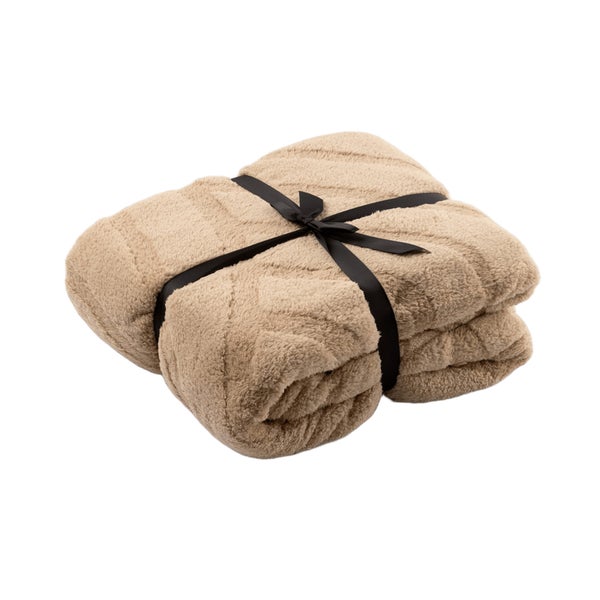 Zusammengefaltete Kuscheldecke mit Schleife