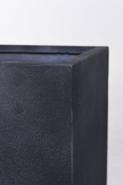 Detailansicht der Ecke eines rechteckigen Pflanzkübels mit einer strukturierten Oberfläche in Steineffekt.