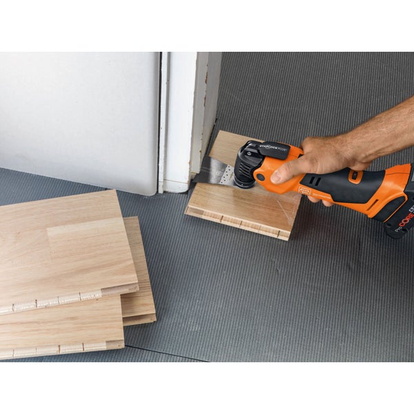 Multifunktionswerkzeug beim Kürzen eines Werkstücks aus Holz an einer Türzarge