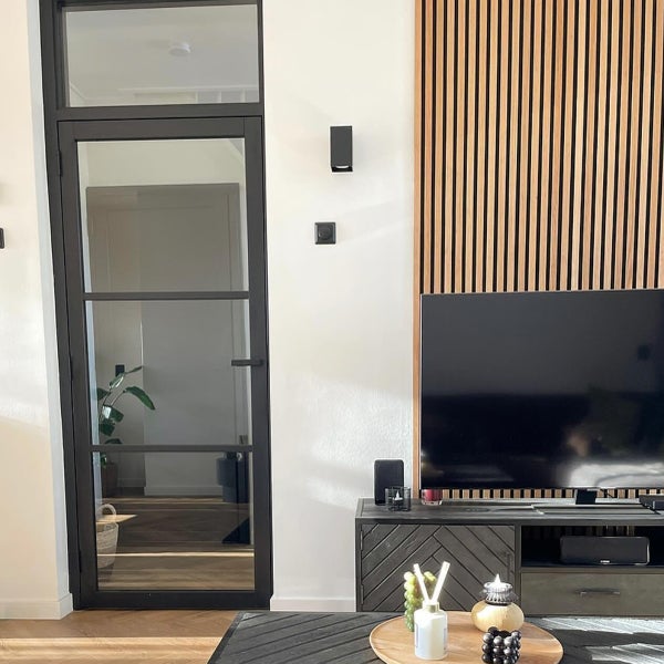 Wohnzimmer mit Glastür, Holzvertäfelung und Fernsehschrank