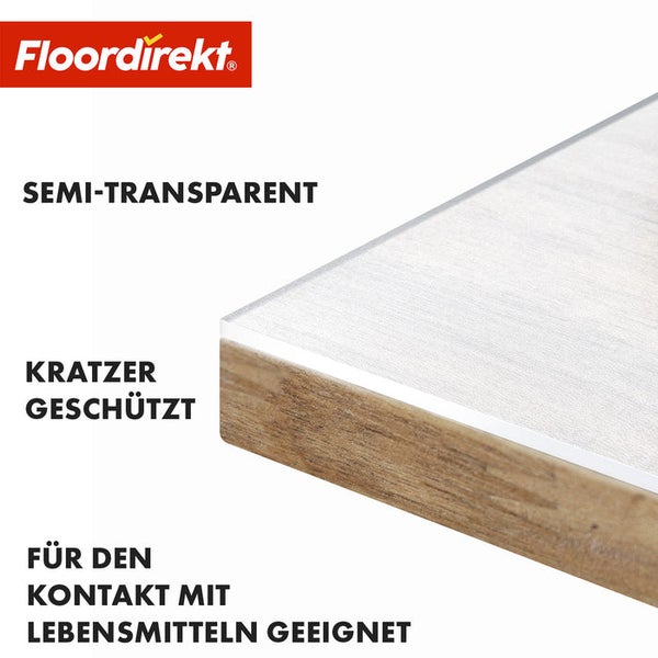 Floordirekt Logo. Detailansicht einer Tischplatte mit einer transparenten Schutzfolie, die vor Kratzern schützt und für den Kontakt mit Lebensmitteln geeignet ist.