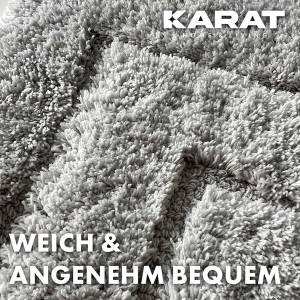 Grauer Teppich mit hohem Flor der Marke Karat Home & Living