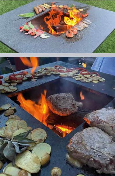 Quadratische Feuerschale mit Grillring aus Stein für den Garten. Fleisch, Fisch und Gemüse garen auf der heißen Platte um das offene Feuer.