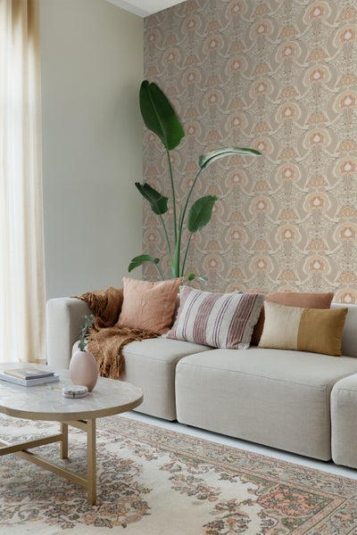 Wohnzimmer mit Sofa, Kissen, Teppich und gemusterter Tapete