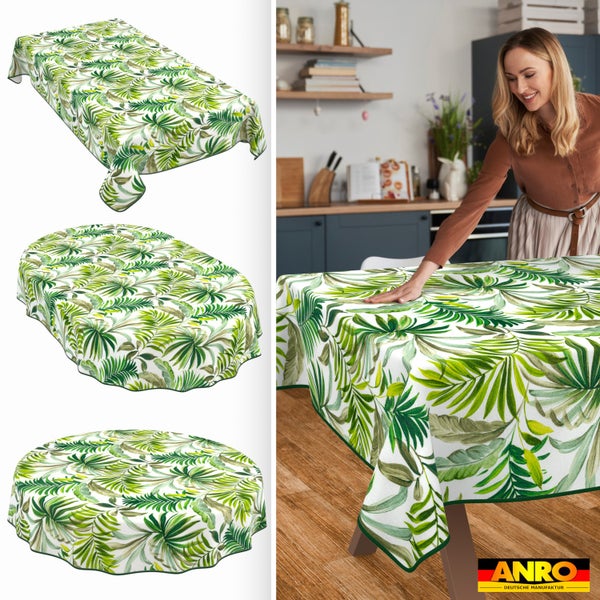 Abwischbare Tischdecke mit Tropen-Blättern in eckig, oval und rund. Anwendungsbeispiel in einer Küche. ANRO Deutsche Manufaktur Logo.
