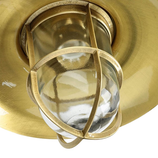 Messingfarbene Wandleuchte mit Schutzgitter und klarem Glas