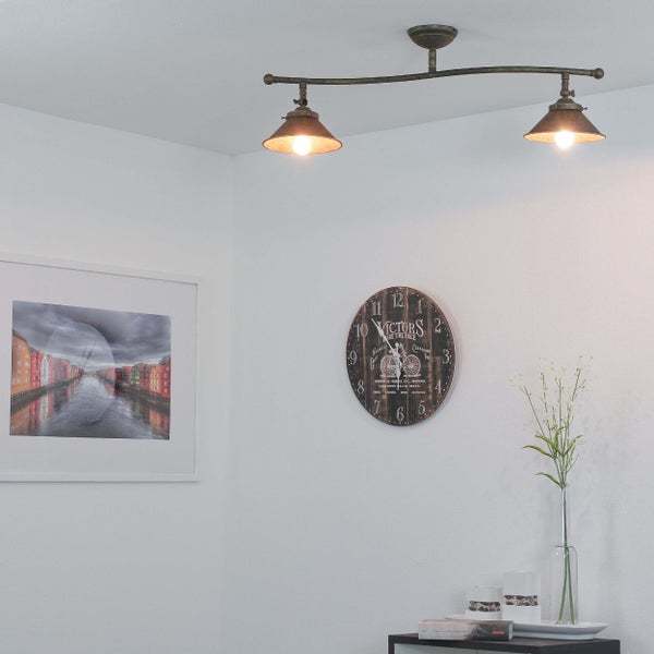 Szene mit einer Deckenleuchte, einer Wanduhr und einem gerahmten Bild