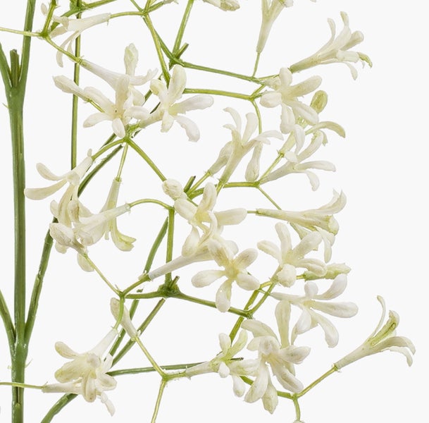 Kunstblume Zweig mit kleinen weißen Blüten und grünen Stielen in der Detailansicht.