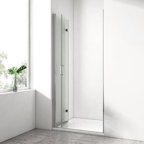Faltbare Duschtür aus Glas mit Metallrahmen in einem hellen, modern gestalteten Badezimmer mit Fenster.