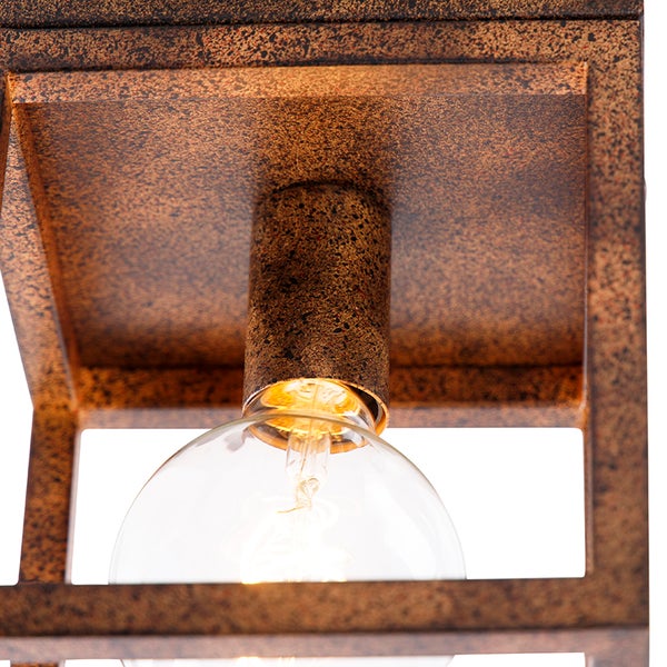 Nahaufnahme einer Deckenleuchte mit metallischem Rahmen und Glühbirne.