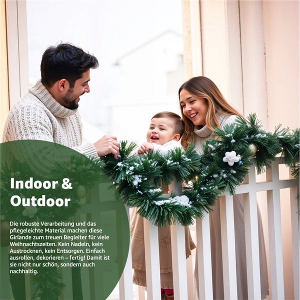 Familie schmückt eine grüne Weihnachtsgirlande mit Dekoration auf einem Balkon