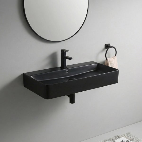 Modernes Wandwaschbecken in Rechteckform mit Armatur und Handtuchhalter an der Wand in einem Badezimmer.